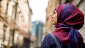 Woman walking past shops