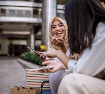 Women laughing sitting down