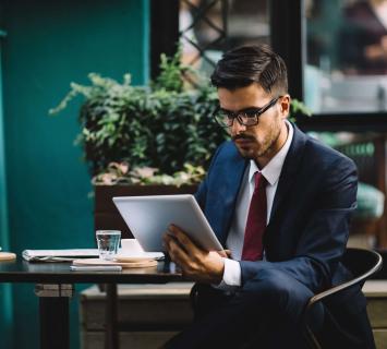 Man in a suit sitting on a chair using a table