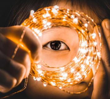 Child gazing through a spiral of lights
