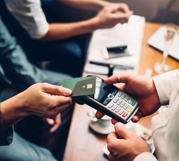 Man tapping contactless card on reader