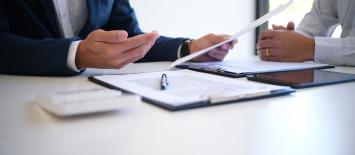Reviewing documents on a white table