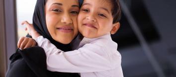 Woman wearing hijab holding a child