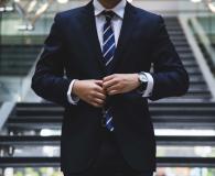 Smart business man adjusting his tie