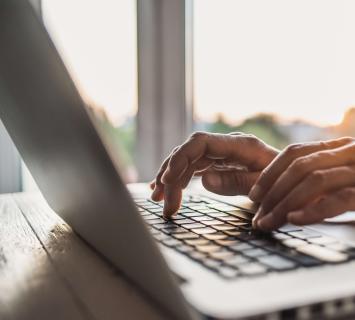 Close up of man using laptop