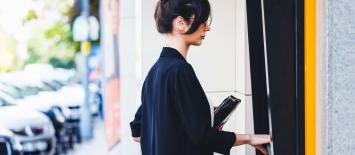 Business woman at ATM using cardless services